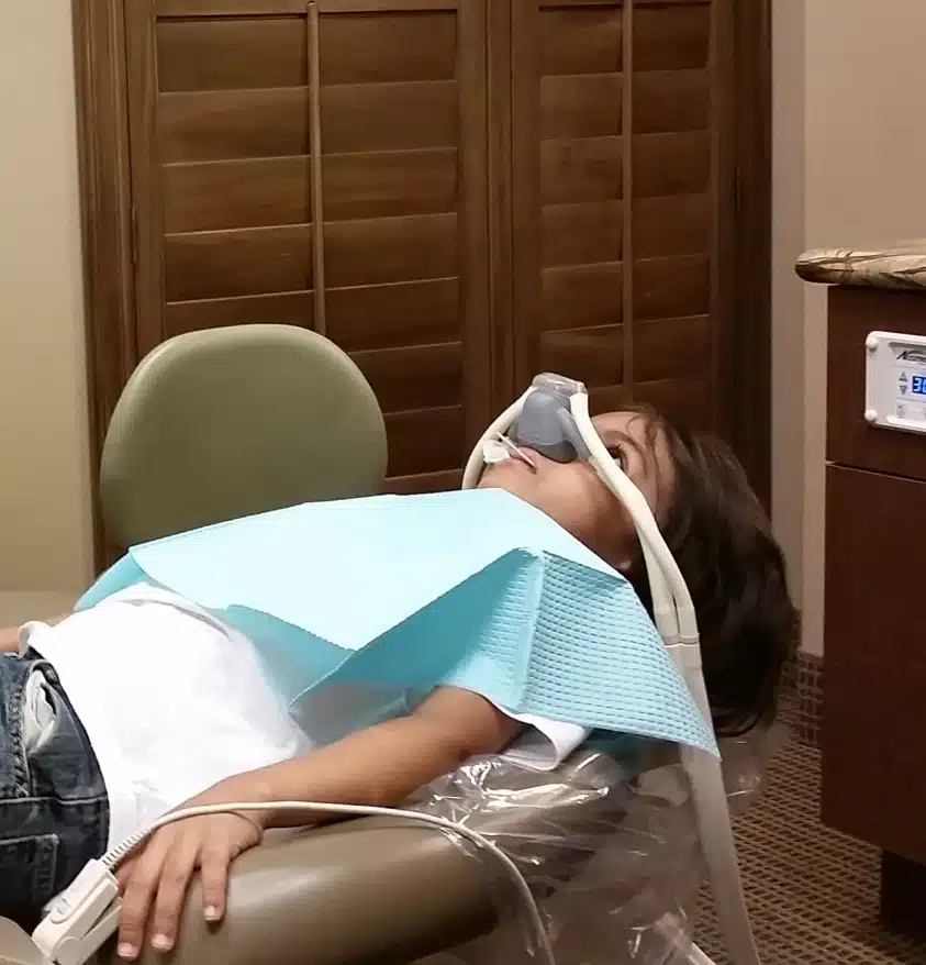 Patient receiving general anesthesia for dental treatment
